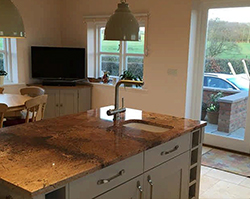 A kitchen of large rural surface tops.