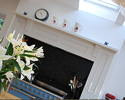 A modern fireplace built within a single story extension.
